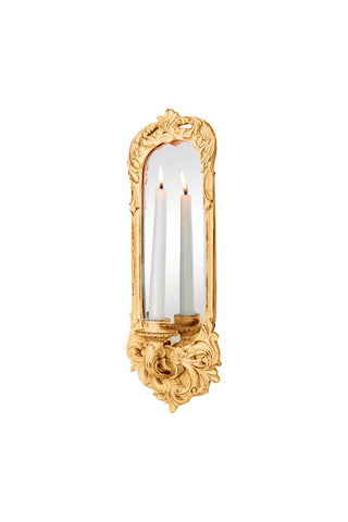 Cutout of a mirrored candle wall sconce with a lit dinner candle inside, on a white background.