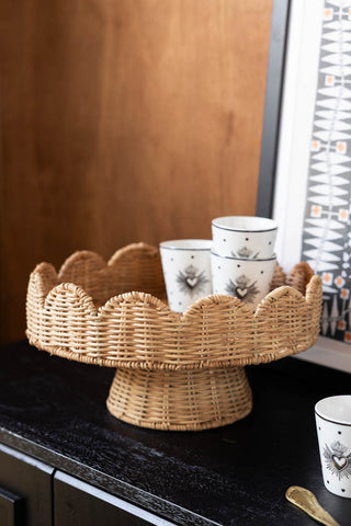 Lifestyle image of the Footed Round Rattan Scalloped Display Stand