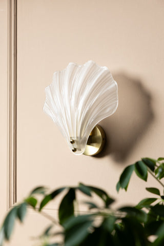 Stunning Frosted Glass Shell Wall Light shown with the light off against a beige panelled wall 