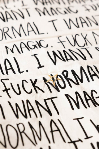 Close-up of the Fuck Normal, I Want Magic Print Reversible Quilt.