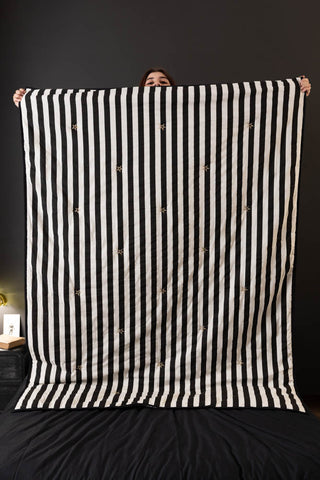 The Fuck Normal, I Want Magic Print Reversible Quilt being held up by a model.