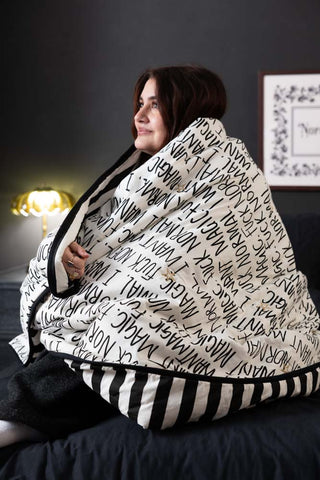 A model wearing the Fuck Normal, I Want Magic Print Reversible Quilt.