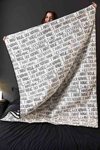 The Fuck Normal, I Want Magic Print Reversible Quilt being held up by a model.
