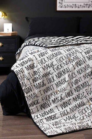 The Fuck Normal, I Want Magic Print Reversible Quilt displayed on a bed.
