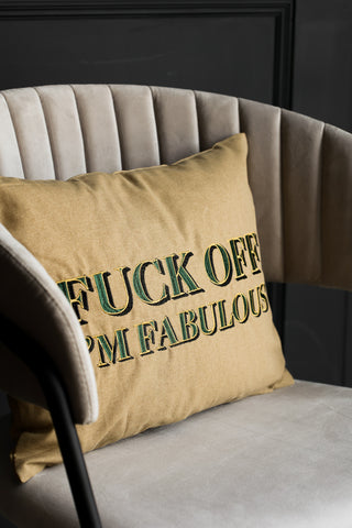Caramel gold typography cushion on a mink dining chair