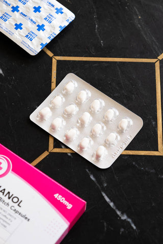 The mints from the Bitchanol Mints Pill Packet on a dark surface.