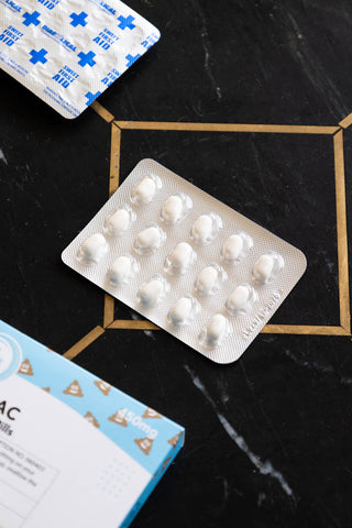 The mints from the Poozac Mints Pill Packet on dark surface.