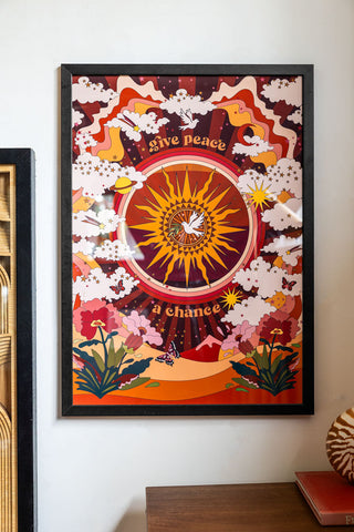 Lifestyle image of the Give Peace A Chance A2 Art Print in a black frame  on a light background
