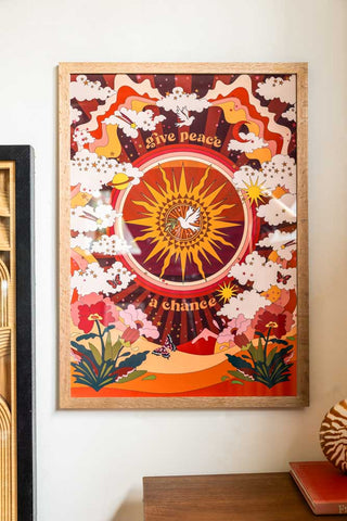 Lifestyle image of the Give Peace A Chance A2 Art Print in a natural frame on a light background