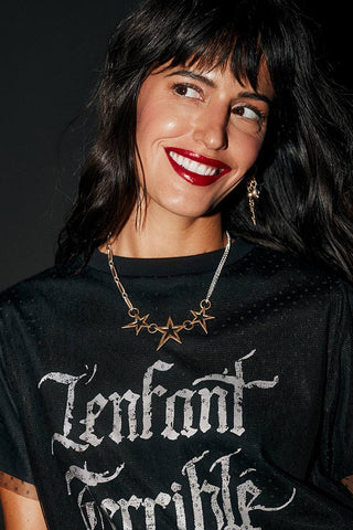The Gold 3 Star Necklace worn by a model.