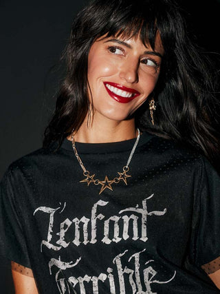 The Gold 3 Star Necklace worn by a model.
