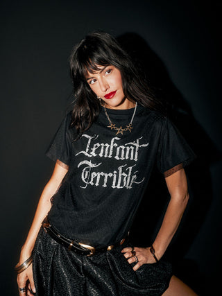 The Gold 3 Star Necklace worn by a model with her hand on her hip.
