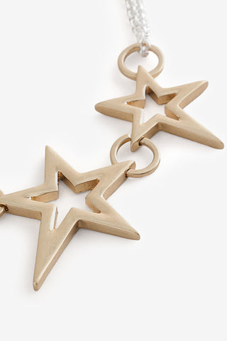 Close-up of the Gold 3 Star Necklace on a white background.