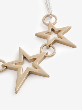 Close-up of the Gold 3 Star Necklace on a white background.