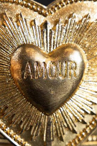The heart detail at the centre of the Gold Amour Heart Trinket Box, with Amour written within the heart.