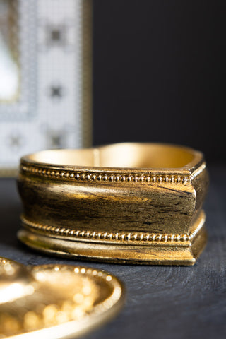 The side of the Gold Amour Heart Trinket Box. 