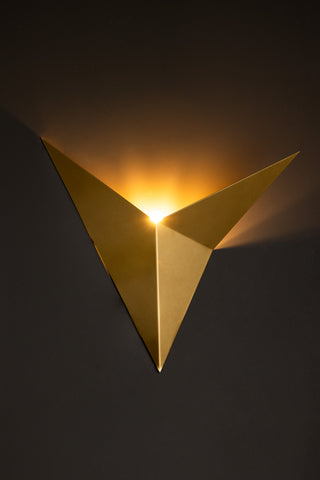 Lifestyle image of the Gold Arrow Metal Wall Light.