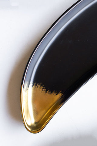 Detail image of one end of the Gold Banana Serving Bowl.