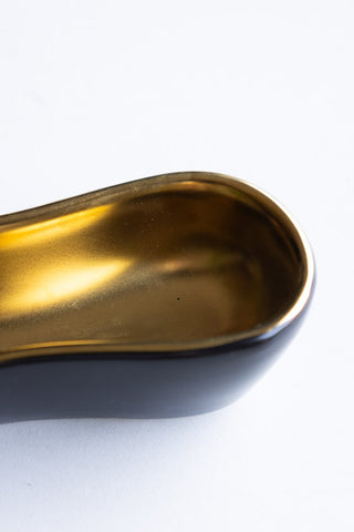 Close-up shot of the end of the Gold Banana Serving Bowl.