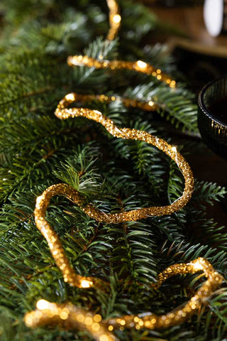 Image of the Gold Beaded Garland with Fairy Lights on a Christmas tree
