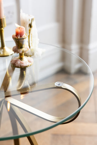 Close-up of the glass top of the Gold Bow Round Glass Side Table.