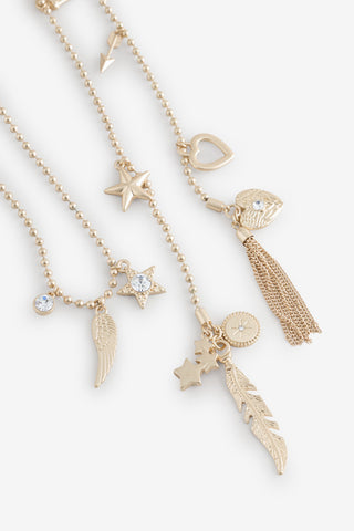 Close-up of the charms on the Gold Charm Wraparound Necklace.