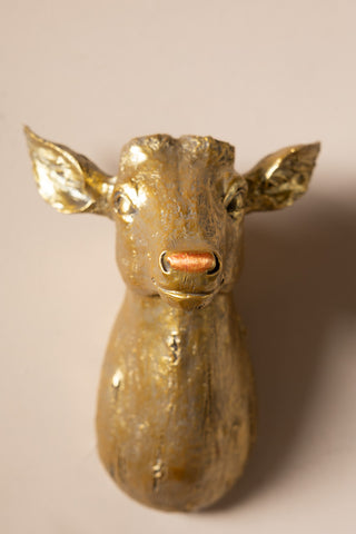 Close-up of the Gold Christmas Reindeer Wall Art Decoration without the antler on, displayed on the wall.