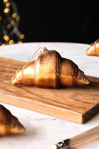 Lifestyle image of the Gold Croissant Glass Christmas Decoration
