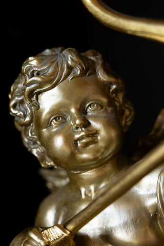 Close-up of the face of the Gold Cupid Table Lamp.