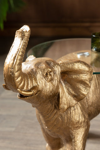 Close-up of the face of the Gold Elephant Side Table With Glass Top.