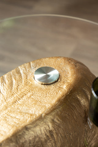 Close-up of the tabletop of the Gold Elephant Side Table With Glass Top.