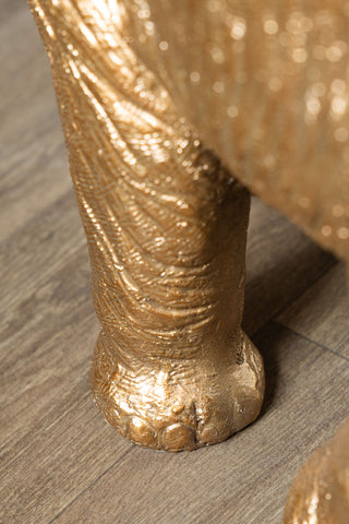 Close-up of the foot of the Gold Elephant Side Table With Glass Top.