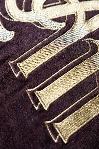 Close-up of gold lettering on a dark background