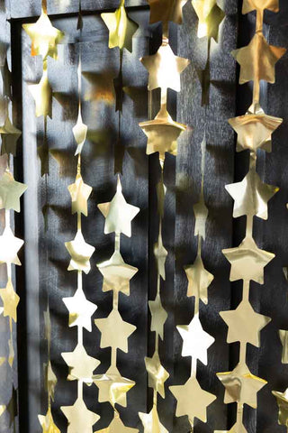 Close-up image of the Gold Star Hanging Christmas Backdrop
