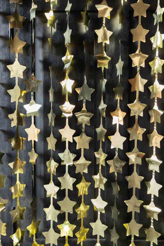Lifestyle image of the Gold Star Hanging Christmas Backdrop