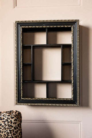 The Ornate Black & Gold Framed Wall Shelf displayed on the wall.