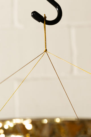 The top of the Gold Tinsel Fringe Chandelier Decoration, showing how it hangs from a hook. 
