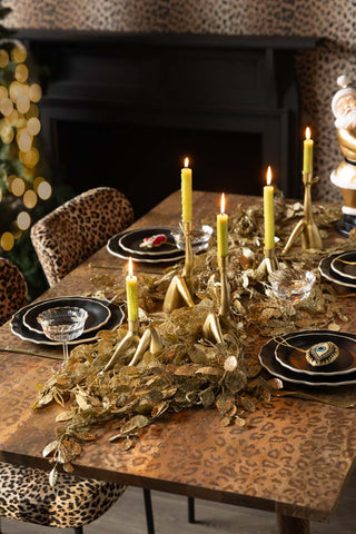 The Gold Glitter Eucalyptus Leaf Christmas Garland styled on a Christmas tablescape.