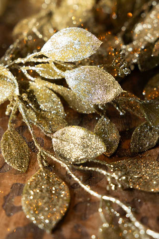 Close-up of the leaves of the Gold Glitter Eucalyptus Leaf Christmas Garland.