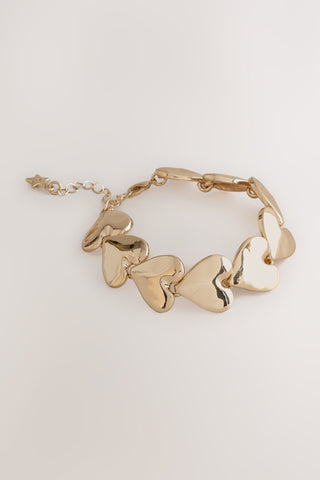 The Gold Heart Bracelet on a white background.