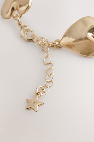 Close-up of the clasp/chain of the Gold Heart Bracelet.
