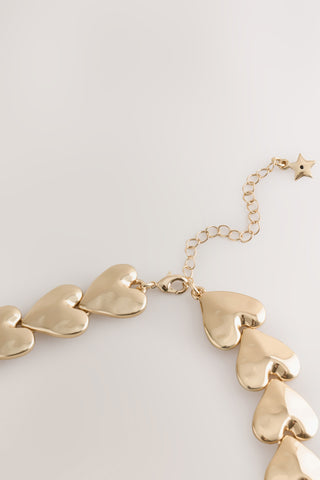 Close-up of the clasp of the Gold Heart Necklace.