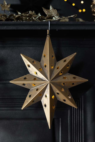 Lifestyle image of the Gold LED Star Light/Christmas Tree Topper