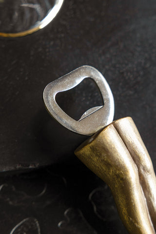 Detail of the bottle opener on the Gold Legs Bottle Opener & Stopper Set. 