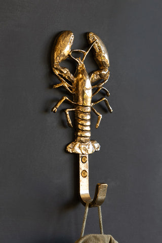 Lifestyle image of the Gold Lobster Coat Hook