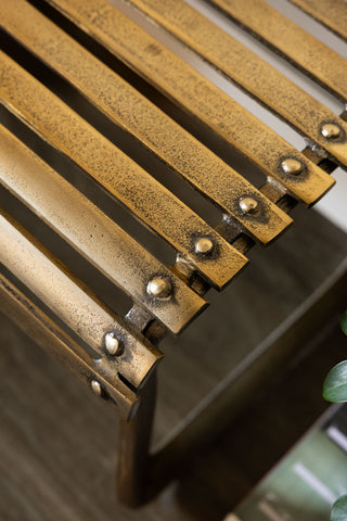 The metal slats on the Gold Metal Bench. 