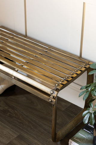The Gold Metal Bench shown in detail with a distressed effect on the gold finish. 