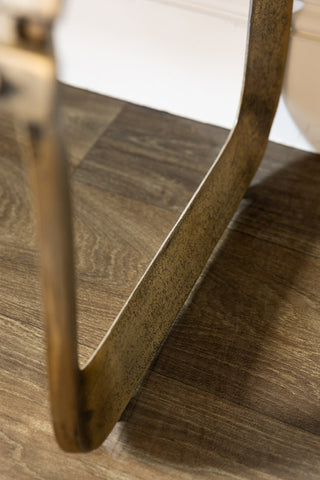 The curved legs of the Gold Metal Bench.