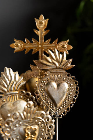 A detail of the gold Milagro hearts in the  Gold Milagro Hearts Glass Dome. 