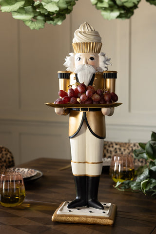 The Gold Nutcracker Butler Christmas Decoration on a Christmas tablescape, styled with some grapes on.